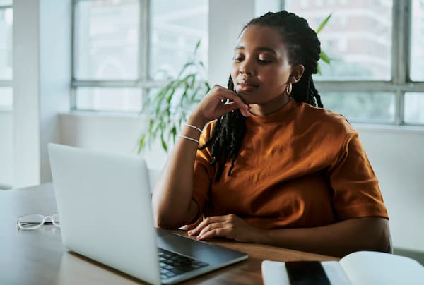 A Young Black Business Woman Working On Her Laptop Computer