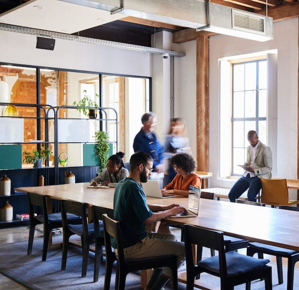 Group Of Diverse Businesspeople Working In A Busy Open Plan Office Space